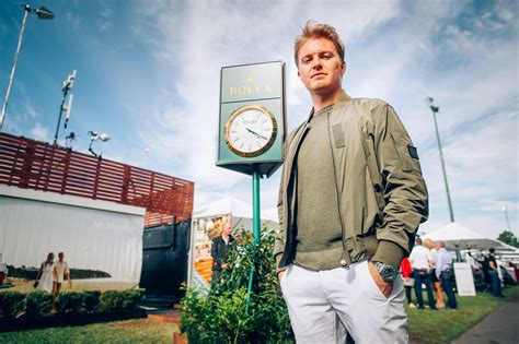 Nico Rosberg keeps time with Rolex .